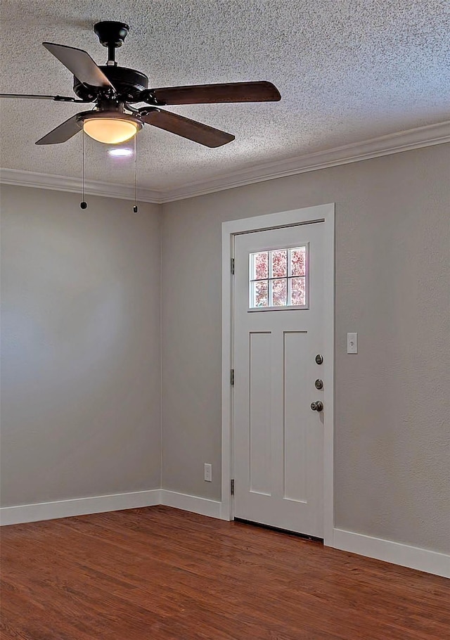 entryway with hardwood / wood-style flooring, ornamental molding, and a textured ceiling