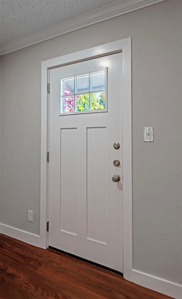 entryway featuring a textured ceiling and dark wood-type flooring