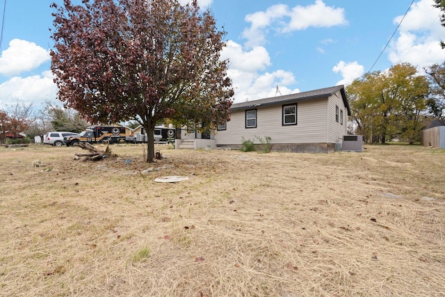 exterior space with a yard and central AC unit