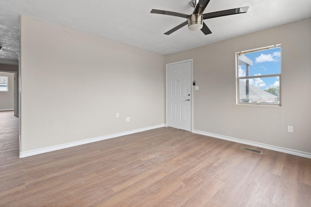 spare room featuring ceiling fan and light hardwood / wood-style floors