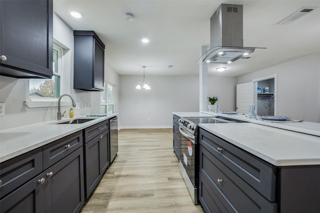 kitchen with sink, decorative light fixtures, light hardwood / wood-style flooring, appliances with stainless steel finishes, and island exhaust hood