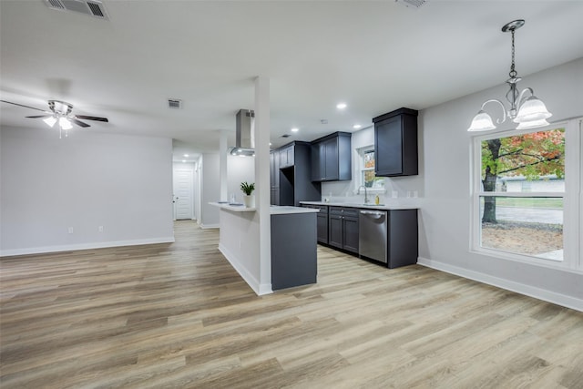 kitchen with wall chimney exhaust hood, decorative light fixtures, dishwasher, light hardwood / wood-style floors, and ceiling fan with notable chandelier