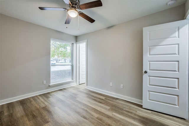 unfurnished room with ceiling fan and light hardwood / wood-style flooring