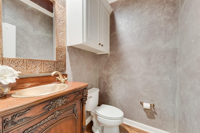 bathroom with vanity, hardwood / wood-style flooring, and toilet