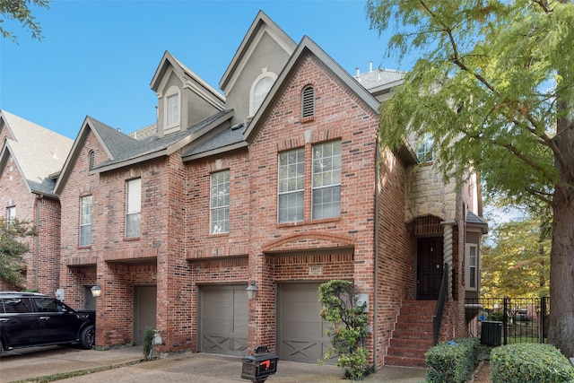 view of front of property with central AC unit and a garage