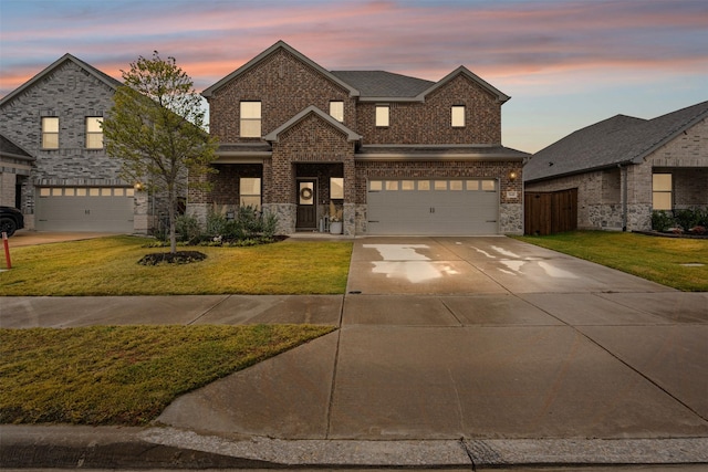 french country inspired facade featuring a lawn and a garage