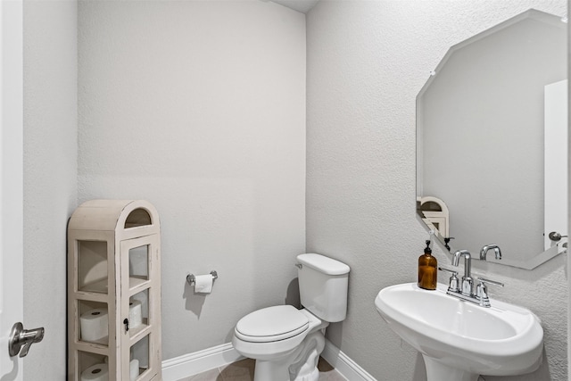 bathroom featuring toilet and sink