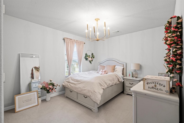 carpeted bedroom featuring a chandelier and a textured ceiling