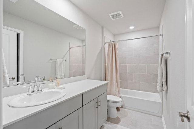 full bathroom featuring tile patterned flooring, vanity, toilet, and shower / tub combo with curtain