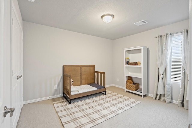 bedroom featuring a textured ceiling and carpet floors