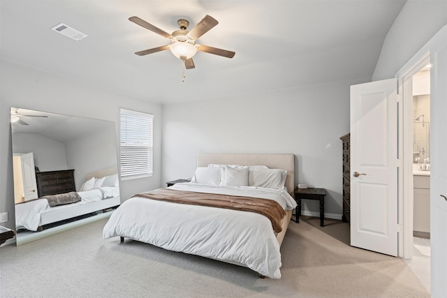 carpeted bedroom with ensuite bath, ceiling fan, and lofted ceiling