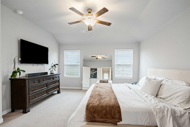 carpeted bedroom with ceiling fan, lofted ceiling, and multiple windows