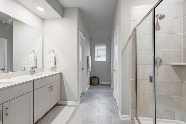 bathroom featuring tile patterned flooring, vanity, and a shower with shower door