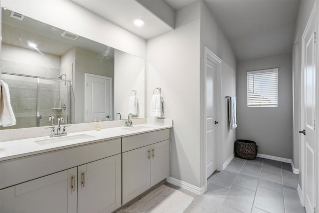 bathroom featuring tile patterned flooring, vanity, and a shower with shower door