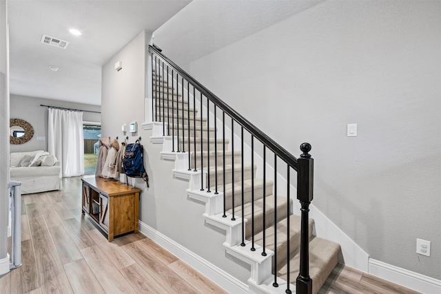 stairs featuring wood-type flooring