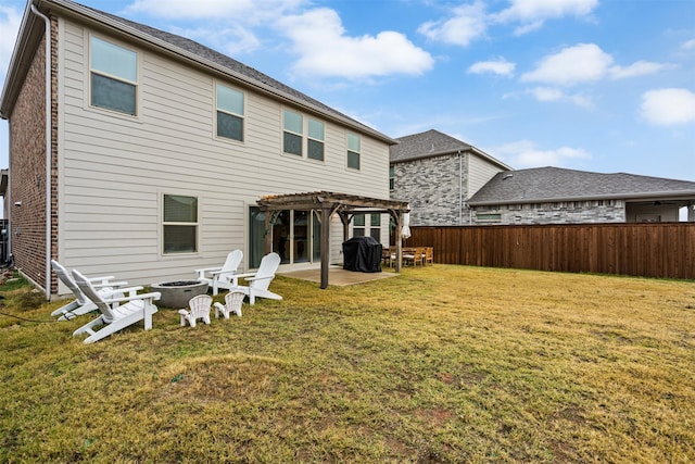 rear view of house with a pergola, a lawn, a patio, and an outdoor fire pit