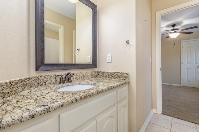 bathroom with tile patterned flooring, vanity, and ceiling fan