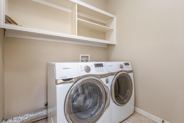 clothes washing area with separate washer and dryer and light tile patterned floors