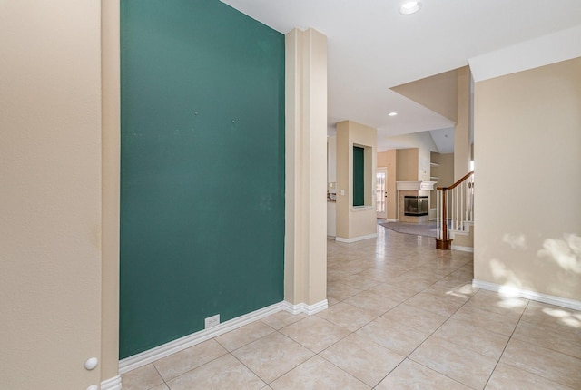 hall featuring light tile patterned floors