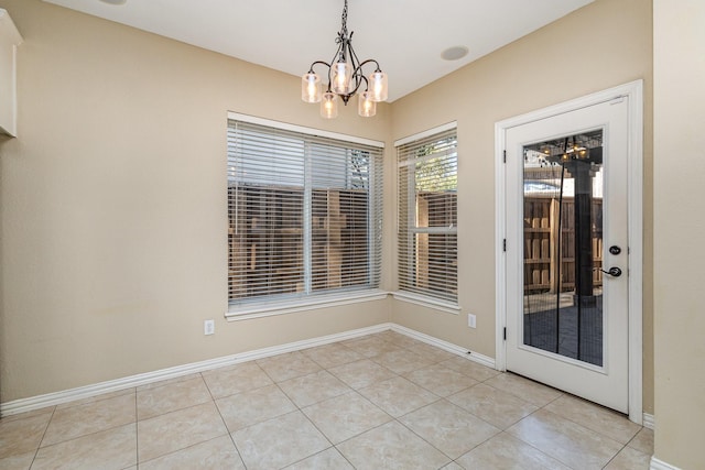 unfurnished dining area with light tile patterned floors and a notable chandelier