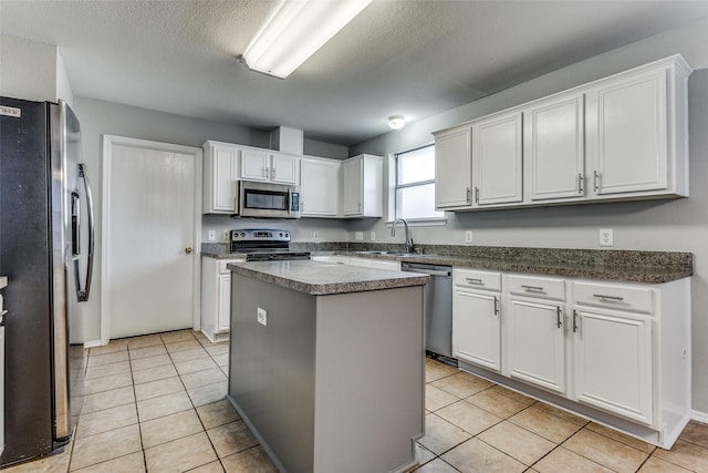 kitchen with a kitchen island, white cabinetry, and appliances with stainless steel finishes