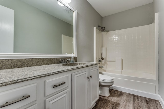 full bathroom featuring vanity, hardwood / wood-style floors,  shower combination, and toilet