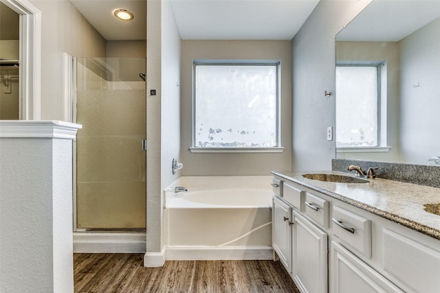 bathroom with vanity, separate shower and tub, and hardwood / wood-style floors