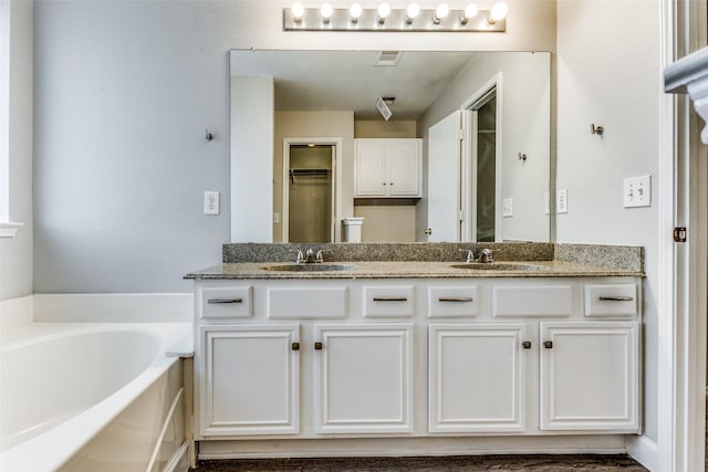 bathroom with vanity and a bathtub