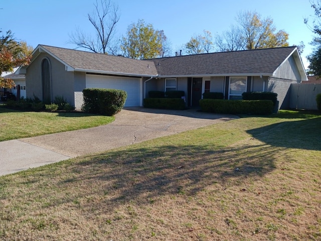 ranch-style house with a garage and a front yard