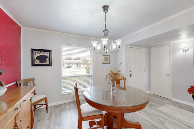 dining area with light wood-type flooring, crown molding, and a chandelier