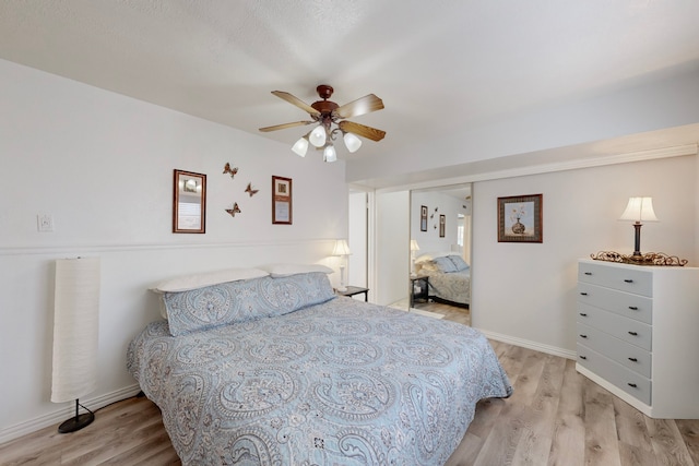 bedroom with light wood-type flooring and ceiling fan