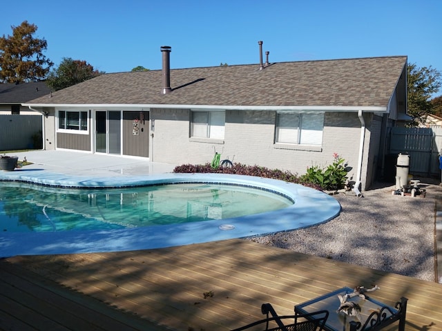 view of swimming pool with a wooden deck and a patio