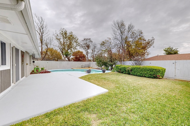 view of yard with a patio area and a fenced in pool