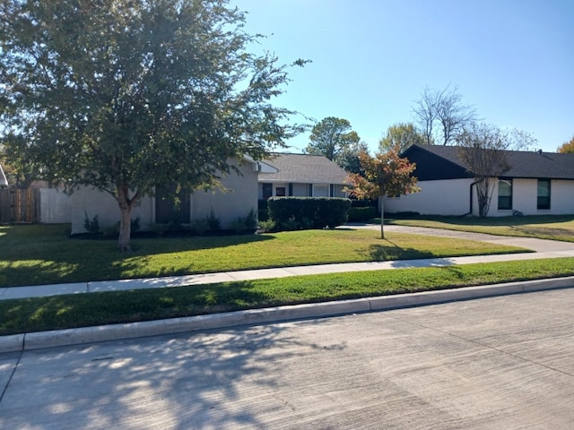 single story home featuring a front lawn