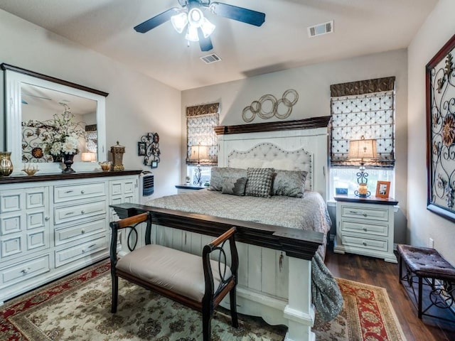 bedroom with multiple windows, ceiling fan, and dark hardwood / wood-style flooring