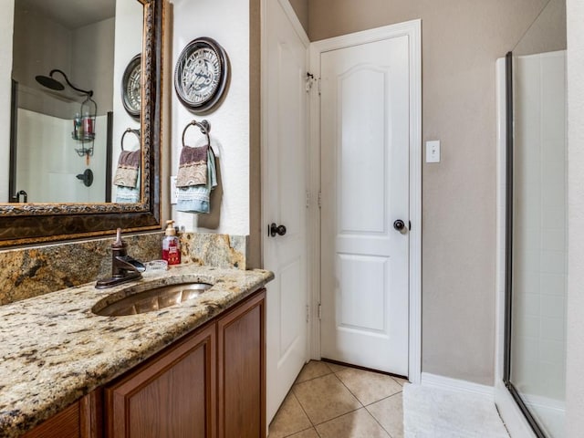 bathroom with tile patterned flooring, vanity, and a shower with door