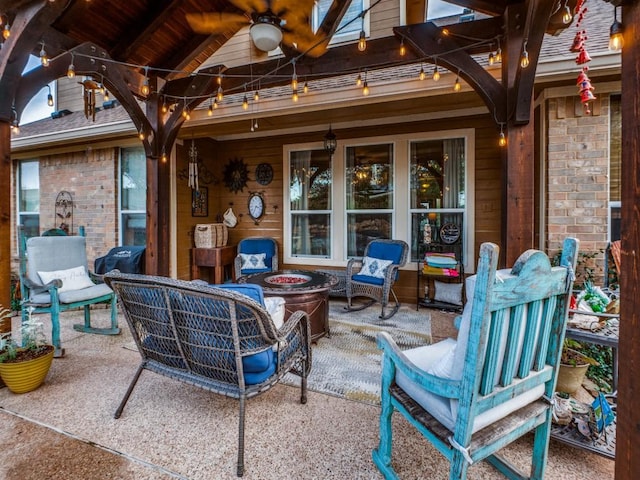 view of patio with ceiling fan and a fire pit