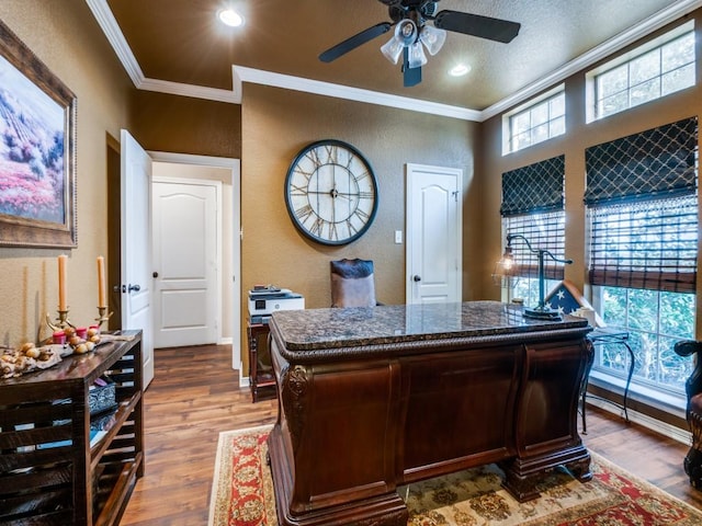 office area with ceiling fan, wood-type flooring, a textured ceiling, bar, and ornamental molding