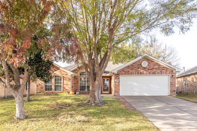 view of front of house with a front yard and a garage