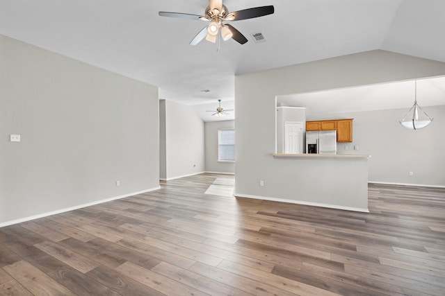 unfurnished living room featuring ceiling fan, dark wood-type flooring, and vaulted ceiling