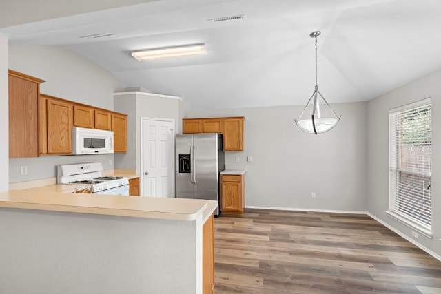 kitchen featuring hanging light fixtures, light hardwood / wood-style flooring, kitchen peninsula, lofted ceiling, and white appliances