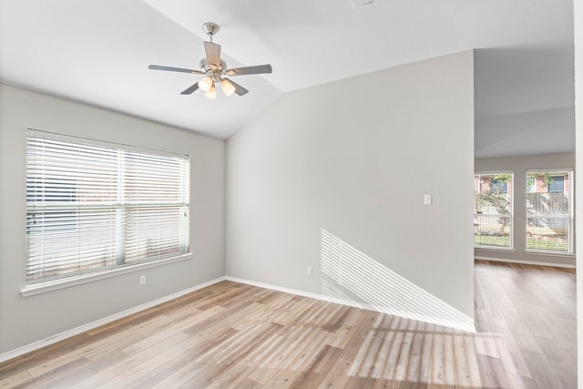 empty room featuring lofted ceiling, ceiling fan, and light wood-type flooring