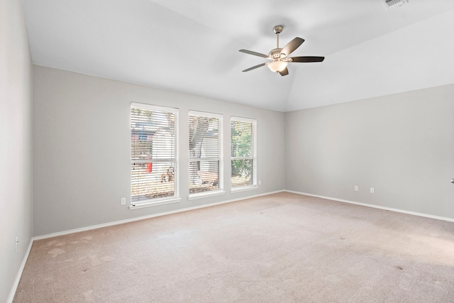 carpeted empty room with ceiling fan and vaulted ceiling