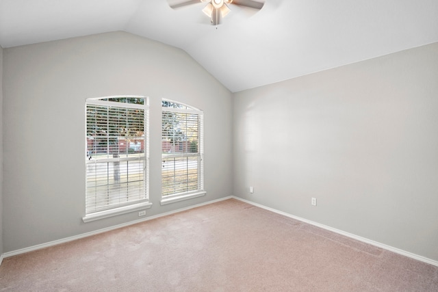 carpeted empty room featuring ceiling fan and lofted ceiling