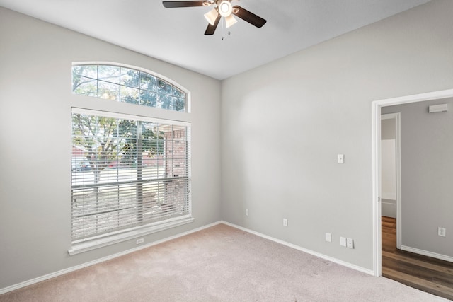 carpeted spare room with ceiling fan