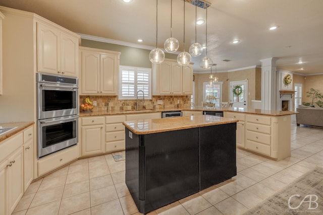 kitchen featuring decorative light fixtures, a center island, stainless steel double oven, and sink