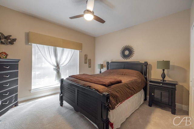 bedroom featuring ceiling fan and light colored carpet