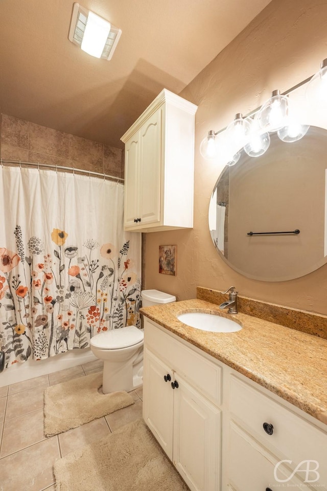 bathroom featuring a shower with curtain, tile patterned flooring, vanity, and toilet