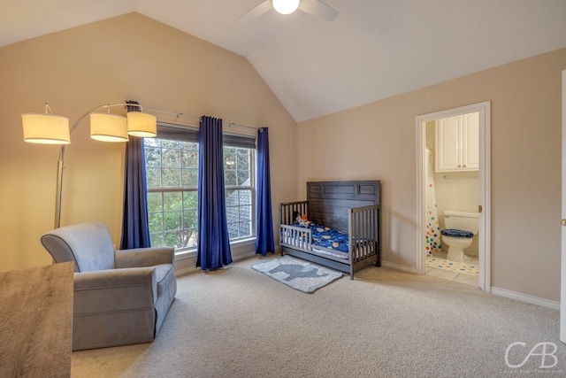 carpeted bedroom featuring ensuite bath, lofted ceiling, ceiling fan, and a crib