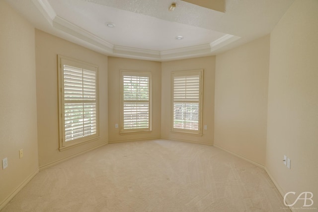 82 Bay Shore Ct, Abilene, TX 79602 - empty room featuring a tray ceiling, carpet flooring, crown molding, and baseboards